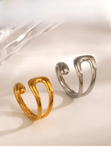 Detailed view of adjustable irregular streamline rings in polished gold and silver finish