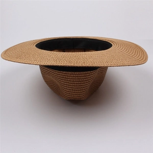 Close-up of spiral woven straw texture and black inner sweatband of the sun hat