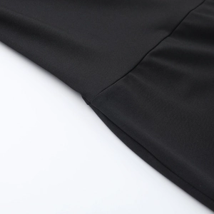 Close-up of high-density black jersey fabric showing fine texture and clean stitching