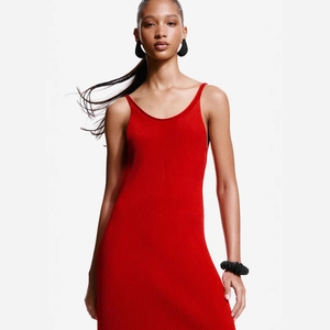 Detail shot of the backless red knitted maxi dress showing texture and slim-fit cut