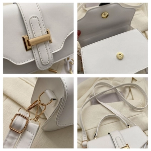 Close-up of white PU leather crossbody bag featuring magnetic buckle and gold hardware details