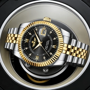 Close-up of luxury men's steel watch featuring gold fluted bezel and black sunburst dial