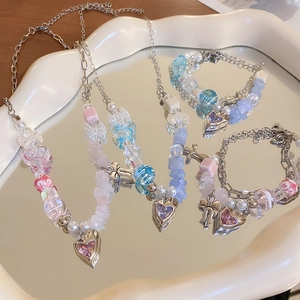 Pastel heart and bow beaded bracelet set in Y2K aesthetic style on a white tray