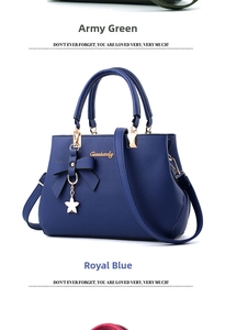 Detail of royal blue leather handbag featuring bow ornament and star pendant