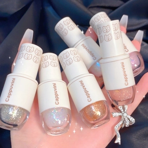 Primer plano de sombras de ojos líquidas brillantes con diseño de oso en la tapa