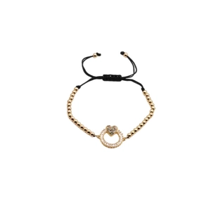 Adjustable woven bracelet featuring golden copper beads and a zircon heart charm