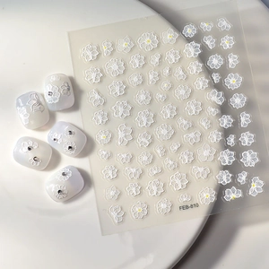 White 5D embossed floral nail stickers with yellow centers and delicate flower patterns