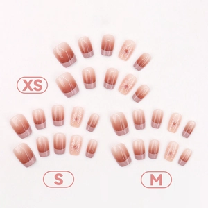 Pink French gradient press-on nails with white floral patterns in three sizes
