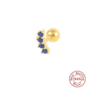 Macro detail of S925 sterling silver gold earring with curved blue zircon stones