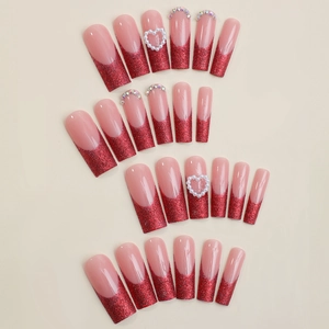 Extra long pink coffin press-on nails with red glitter french tips and heart rhinestones