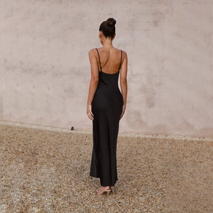 Rear view of sleek black satin maxi dress featuring a deep V-neck and open back design