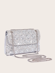 Detail of silver evening clutch bag with sparkling floral rhinestone pattern and chain