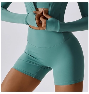 Detail view of turquoise thumbhole long sleeve top and high waist yoga shorts set