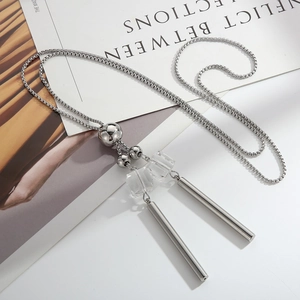 Minimalist silver sweater necklace with long metal tubes and transparent glass beads