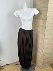 Detail of white short sleeve slim T-shirt paired with dark brown pleated wide leg pants