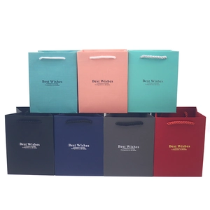 Multiple colors of paper gift bags with Best Wishes gold foil text and rope handles