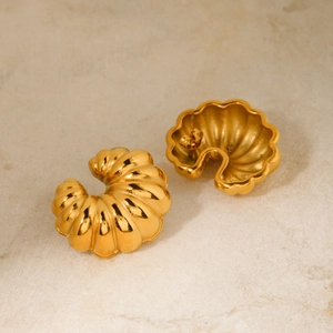 Macro shot of 18k gold stainless steel croissant earrings with wave relief texture