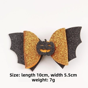 Detail view of Halloween bat wing bow clip with pumpkin motif, 10cm x 5.5cm size