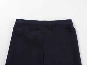 Detailed view of the high-waisted stitching on dark blue athletic yoga shorts