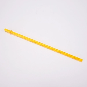 Detail view of a yellow Tritan reusable straw with spiral twisted design and ring stopper