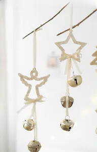 Champagne gold Christmas angel and star ornaments with bells on a branch
