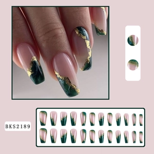 Detail view of pink ballet nails with green ombre tips and gold foil accents