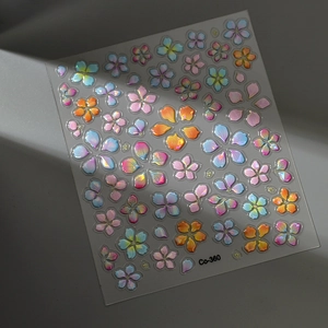 Macro view of 3D embossed floral nail stickers with iridescent finish and shell luster