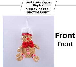 Close-up of plush gingerbread man with chef hat and red bow for Christmas tree decor
