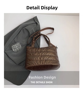 Detail view of brown quilted nylon puffer tote bag with glossy metallic finish and strap