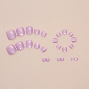 Macro view of purple cat-eye press-on toenails with pearlescent finish and multiple sizes