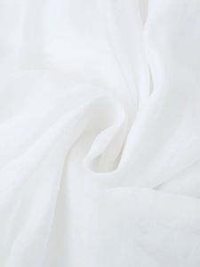 Macro shot of white semi-transparent chiffon fabric showing texture and soft draping folds