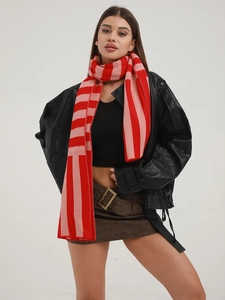 Close-up of red and pink striped knit scarf texture on model for winter warmth
