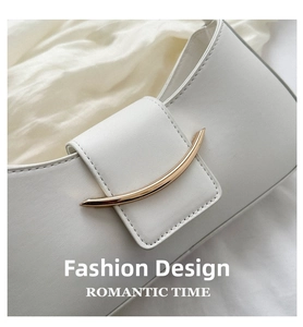 Detail shot of white leather underarm bag with gold metal buckle and stitching