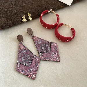 Three-piece set of vintage earrings featuring fish studs and diamond pearl details