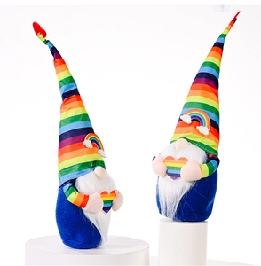 Detail of plush rainbow gnomes with striped hats holding colorful stuffed hearts