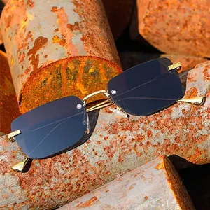 Frameless square sunglasses with gold metal temples and dark gradient lenses