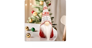 Close-up of a festive Christmas gnome featuring a grey knitted hat with snowflake patterns