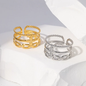 Detailed macro view of gold and silver layered rings with star and chain patterns