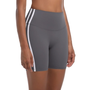 Detail of high-waisted gray yoga shorts with white side stripes and stretch knit fabric