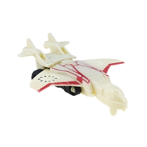 Detail of a white sci-fi toy plane with red stripes and black wheels on a white background