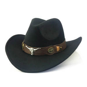 Detail of black cowboy hat with brown leather band and silver bull head metal ornament