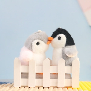 Cute plush penguin bag charms for couples in grey and pink, perfect as schoolbag keychains