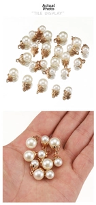 Macro view of mini pearl alloy pendants in flower petal settings for DIY jewelry making