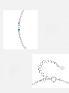 Macro detail of S925 sterling silver beaded bracelet with sky blue bead and hallmark