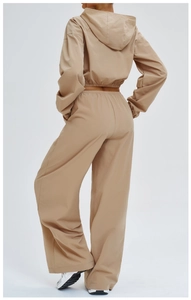 Rear view of women's hooded sports set featuring a cropped windbreaker and wide-leg trousers