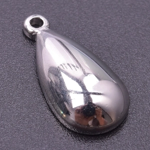 Close-up of polished silver stainless steel water drop pendant with metallic luster
