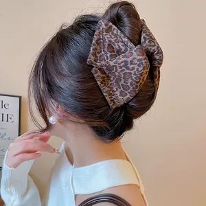 Large leopard print bow hair claw clip for elegant back-of-head styling on woman