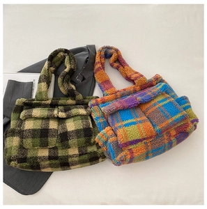 Flat lay of plaid plush tote bags featuring front double pockets and fluffy texture