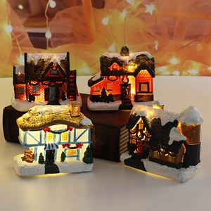 Set of 4 illuminated resin Christmas village houses with warm LED lights and faux snow
