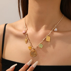 Close-up of colorful bohemian woven necklace with diverse charms and a golden square tag